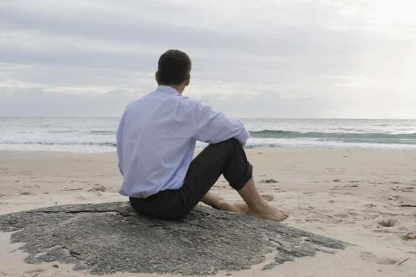 businessman-contemplating-sea-while-sitting-barefoot-600nw-10026634